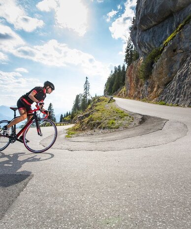 Cyclist riding a road bike on a winding mountain road
