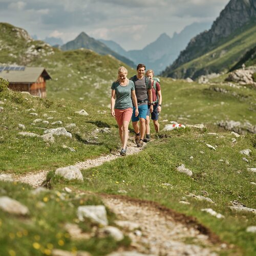 Group of hikers walking along a rocky mountain path