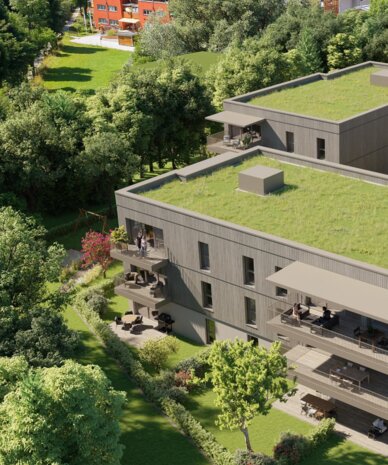 Modern residential complex with green roofs along river