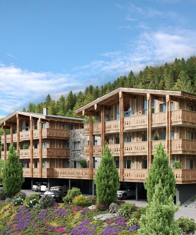 Three-storey wooden apartment buildings on a hillside with balconies and parking