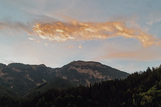Mountain range with forested slopes at sunset