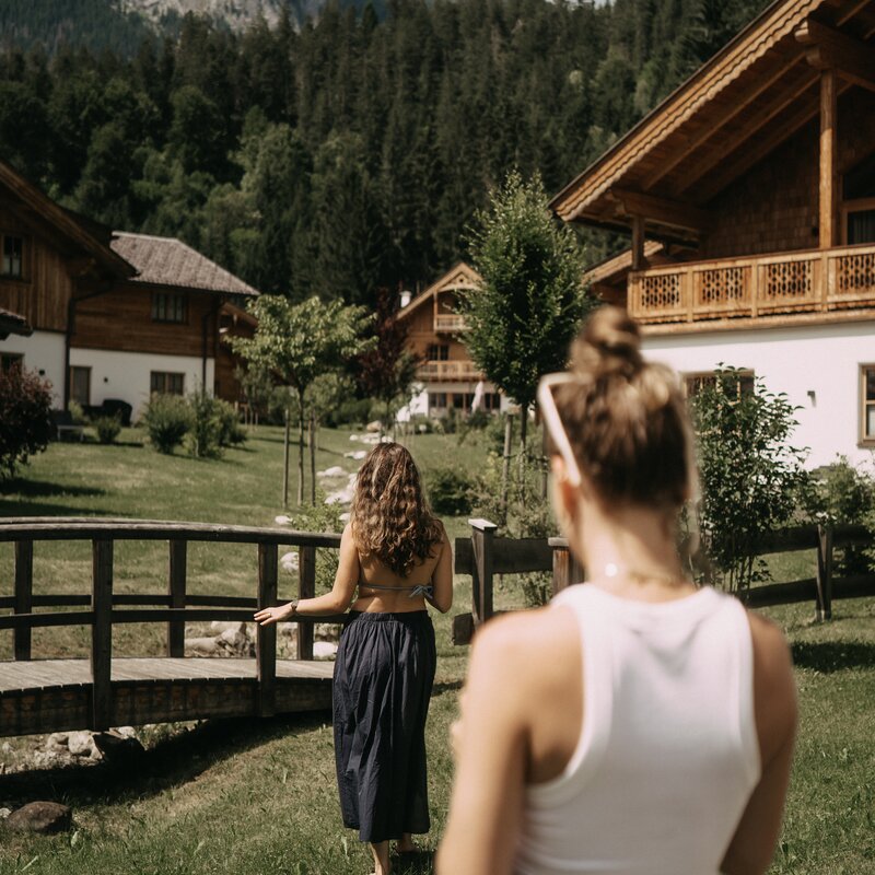 Two women in a mountain village with wooden chalets