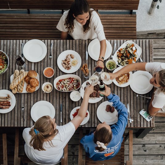 Top-down view of friends sharing an outdoor meal