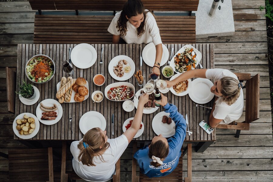 Top-down view of friends sharing an outdoor meal