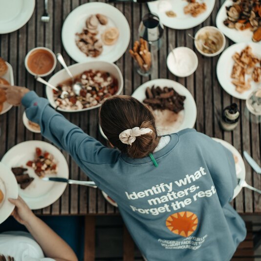Top-down view of people sharing a meal outdoors.