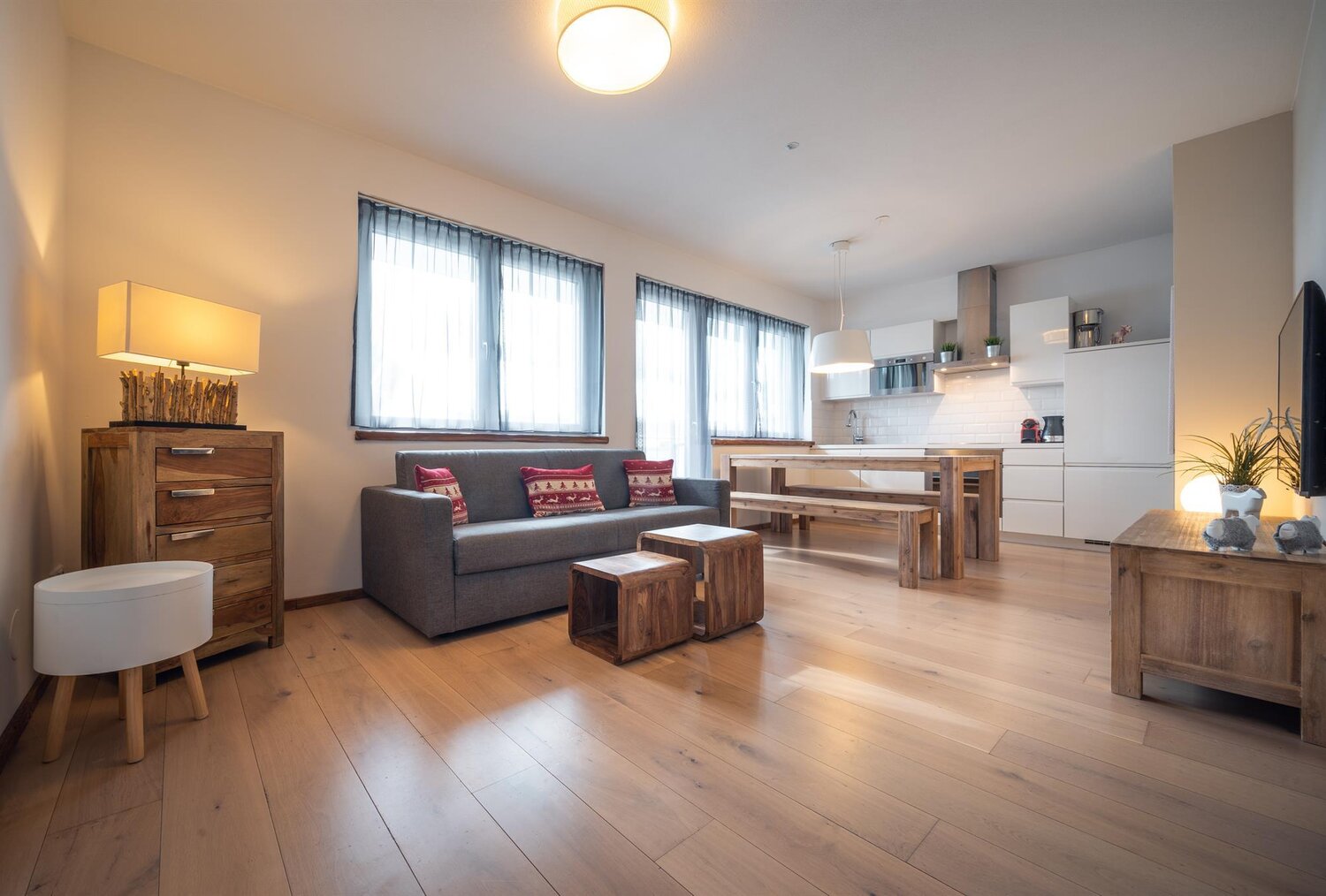 Open living area with sofa, dining table and wooden furniture
