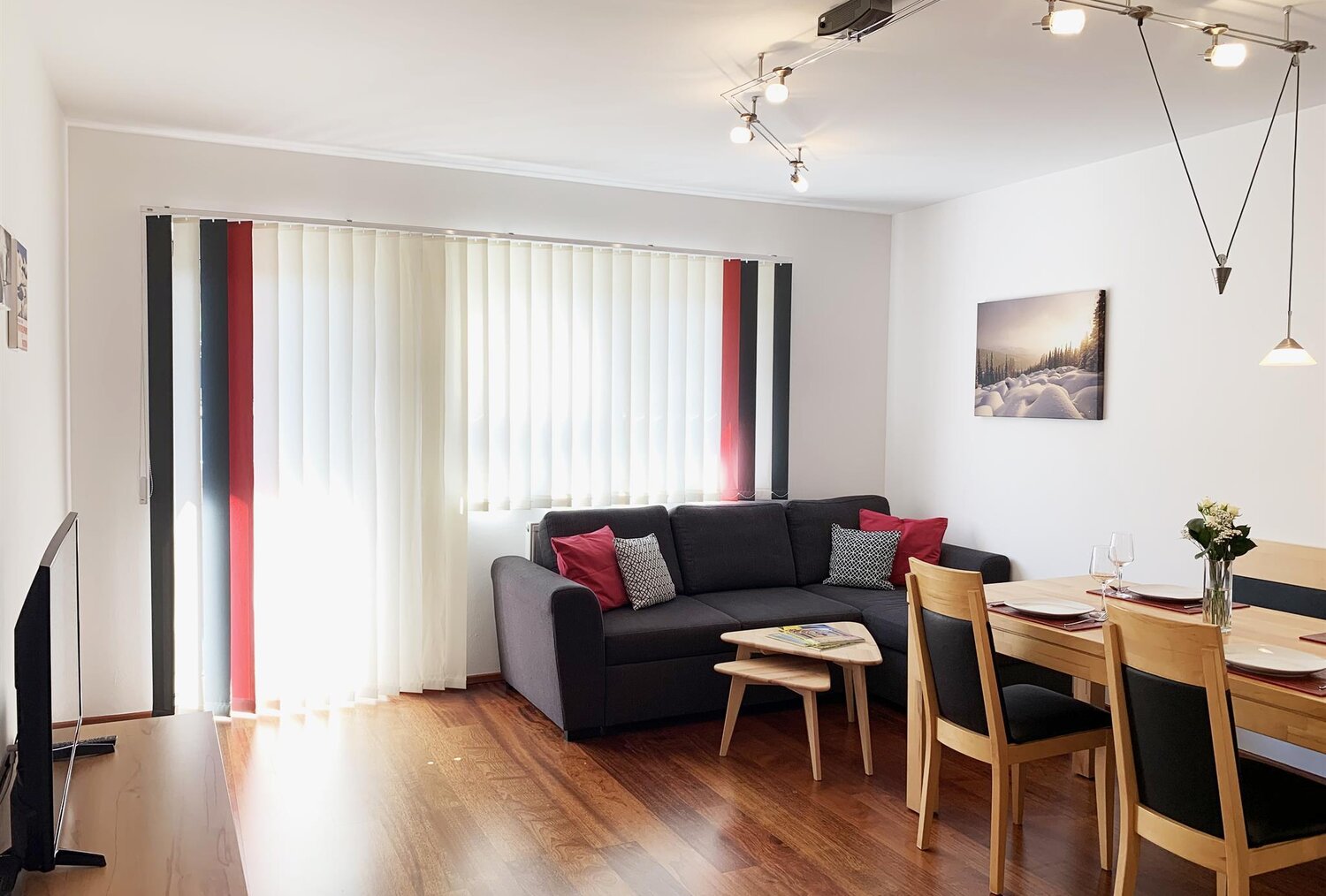 Bright living room with sofa and dining area