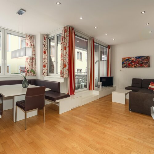 Bright modern living room with corner dining nook and sofa.