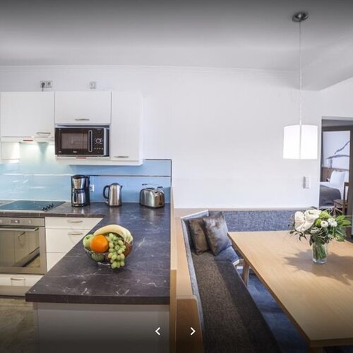 Open-concept kitchen and dining area with island and fruit bowl