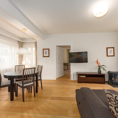 Bright living room with dining area, TV, and fireplace