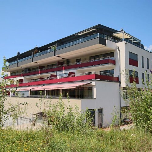 Modern multi-story apartment building with balconies