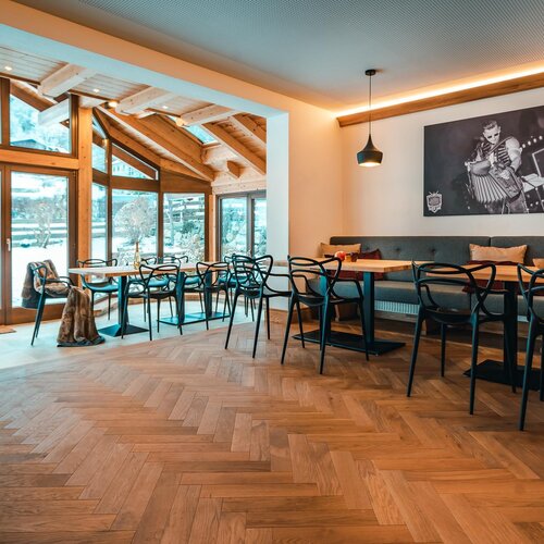 Cozy cafe interior with wooden beams and large windows