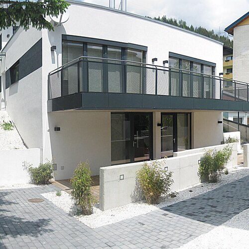 Modern white building with balcony and stairs