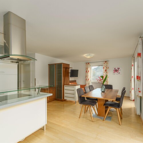 Open-plan kitchen and dining area with wooden floor