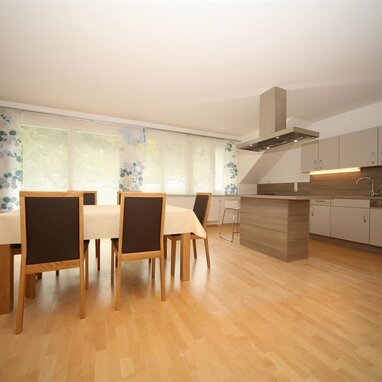 Spacious modern kitchen with island and dining table