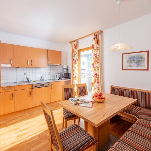 Bright kitchen with wooden cabinets and dining area