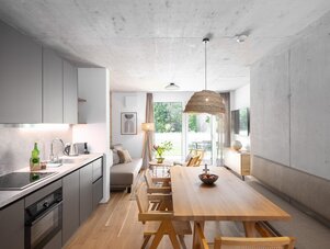 Open-plan kitchen and living area with dining table