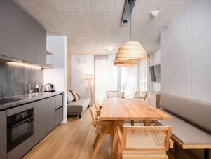 Open-concept kitchen and dining area with wooden table and seating