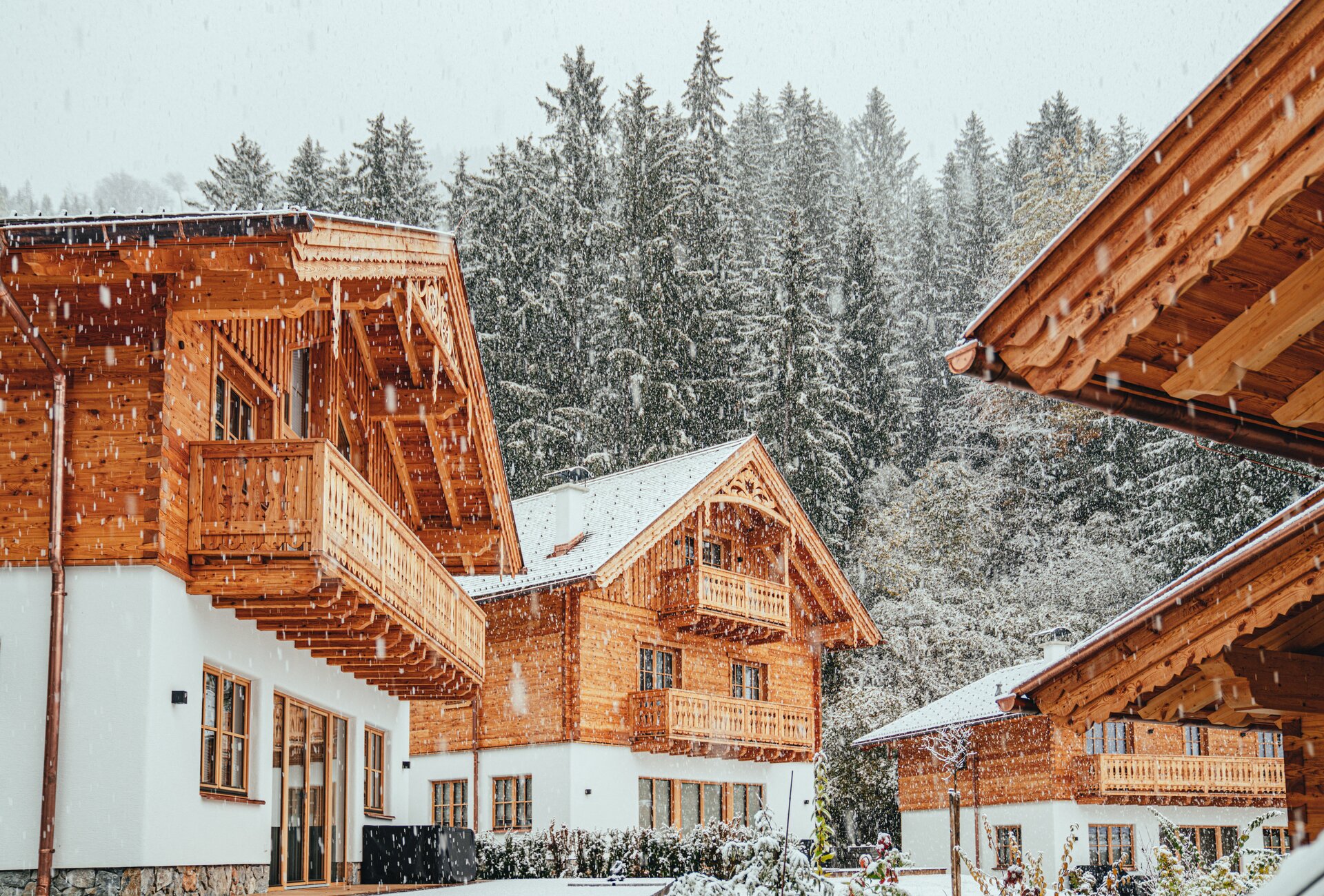 Snowy scene of wooden chalets in forest
