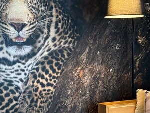 Leopard mural beside modern living room furniture