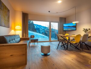 Spacious living and dining area with wooden floors and mountain view