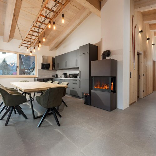 Modern open-plan kitchen and dining area with a fireplace