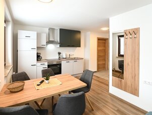 Open-plan kitchen and dining area with wooden flooring