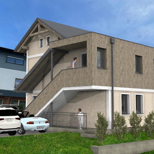 Two-story building with a wooden extension and balcony, restaurant signage nearby.