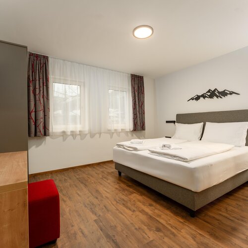 Hotel room with king bed, two nightstands and window