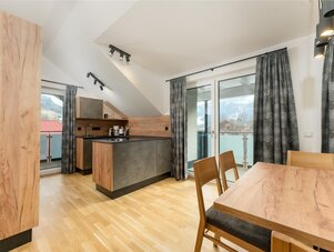 Modern kitchen and dining area with wooden surfaces