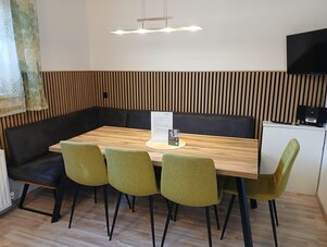 Wooden table with green chairs in a conference room