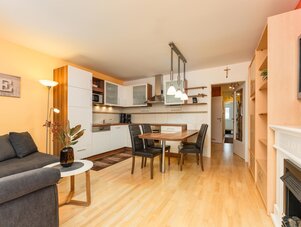 Open-plan living area with kitchen and dining table.
