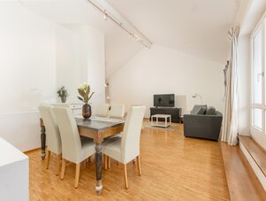 Bright open-plan dining area with a wooden table