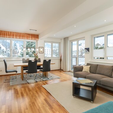 Bright open-plan living and dining room with large windows