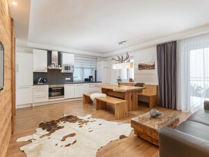 Open-plan kitchen and dining area with wooden furniture