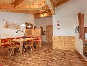 Rustic dining area with wooden beams and wall sign