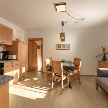 Bright kitchen and dining area with wooden cabinets and table