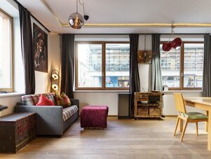Cozy living room with gray sofa and plaid cushions.