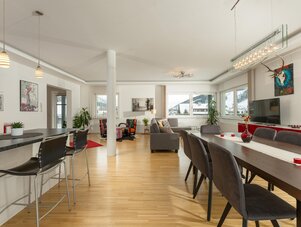 Spacious open-plan living and dining area with large windows