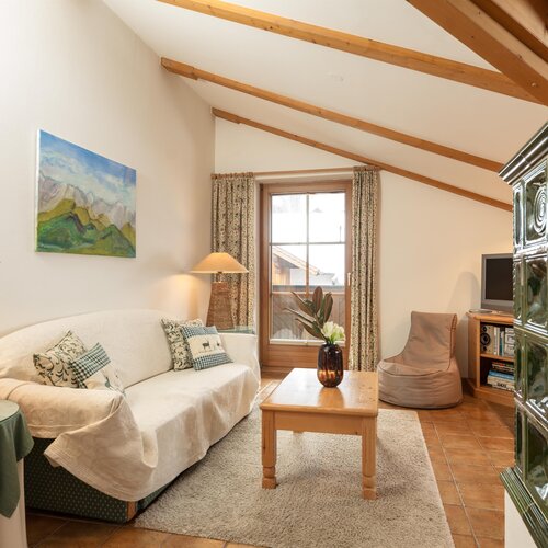 Cozy living room with white sofa and wooden beams