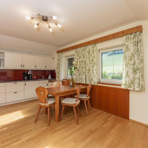 Wooden dining table and chairs in bright kitchen area