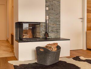 Modern living room fireplace with log basket and tools