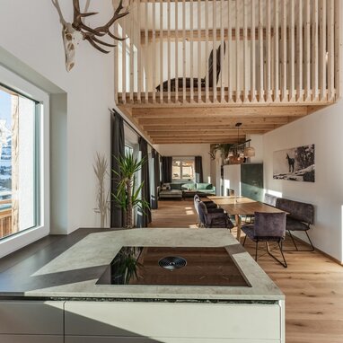 Open-plan living and dining area with kitchen island and loft