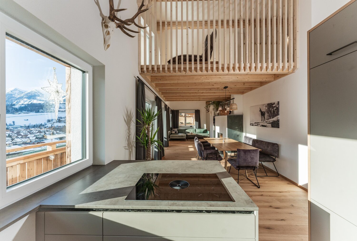 Open-plan living and dining area with kitchen island and loft