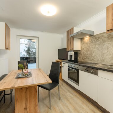 Modern kitchen with wooden dining table and bench seating