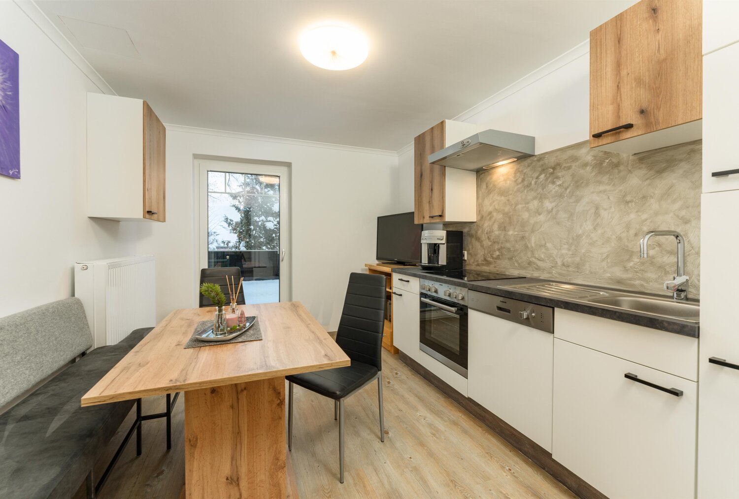 Modern kitchen with wooden dining table and bench seating